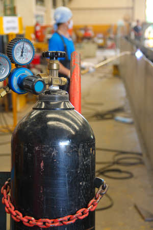 This image is gas tank used in the industry with worker backgroundの写真素材