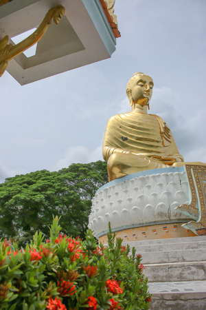 Gold Buddha statue temple on the blue sky as a background.の写真素材