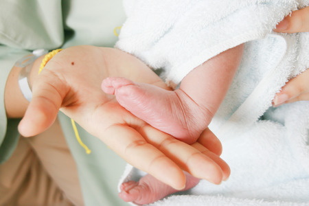 Warm love between mother and child, a newborn baby.の写真素材