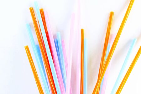 Multi color drinking straws on a white background, abstract pattern.の写真素材