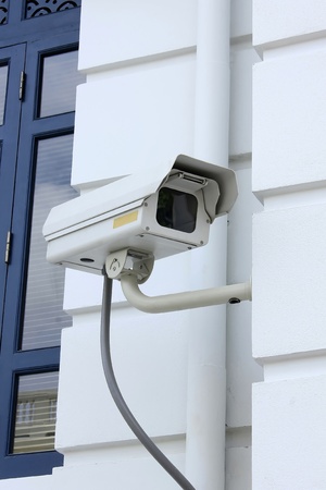 A CCTV Camera on the white wall.の写真素材