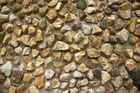 Stone wall made of various sizes stone, can be used as background の写真素材