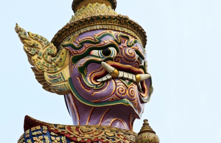 Close up face of one of twelve giant guardians, characters from the Thai Ramakien epic, guarding the gate of Wat Phra Kaew  It has a green face  の写真素材