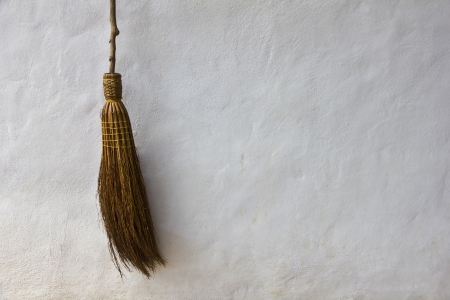 Broom on white wall in backgroundの写真素材