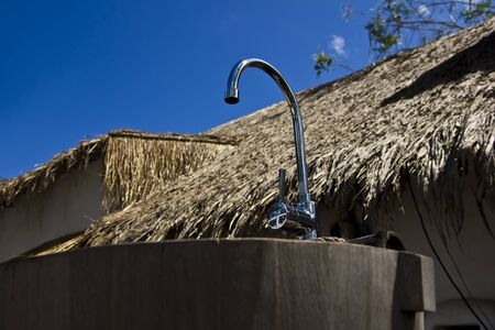 A Stainless faucet and wooden sink, focus on sinkの写真素材