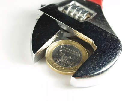  wrentch key with euro coin in a white backgroundの写真素材