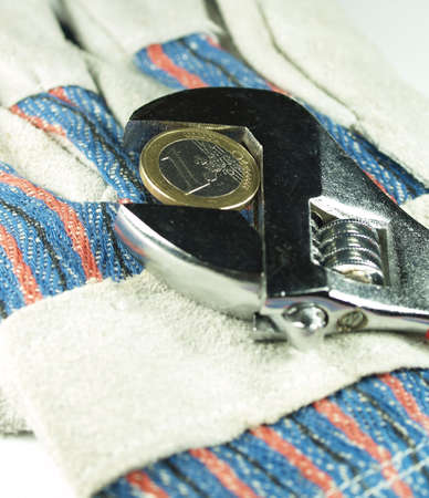  wrentch key with euro coin on a work glovesの写真素材