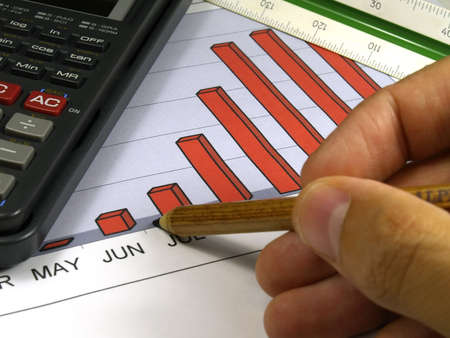 sales graph pen and hand