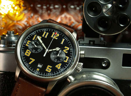 vintage watch over a vintafe cameraの写真素材