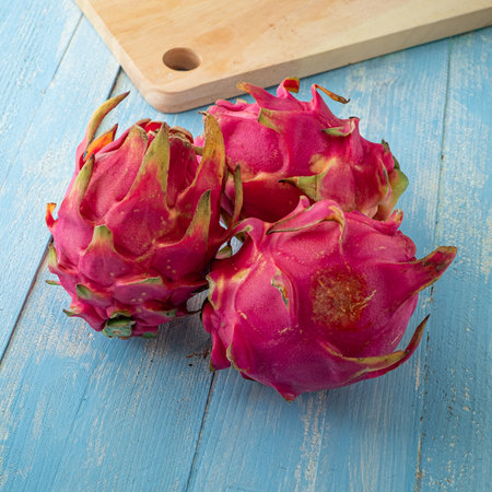 Fresh tropical fruits, sliced cube dragon fruits on blue wooden backgroundの写真素材
