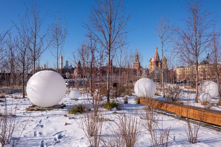 Moscow, Russia - February 8, 2020: View of the Moscow Kremlin, Ivan the Great Bell-Tower, Spasskaya tower and St. Basil's Cathedral from Zaryadye Park on sunny winter day. In the foreground Large ball-shaped lanterns.のeditorial素材