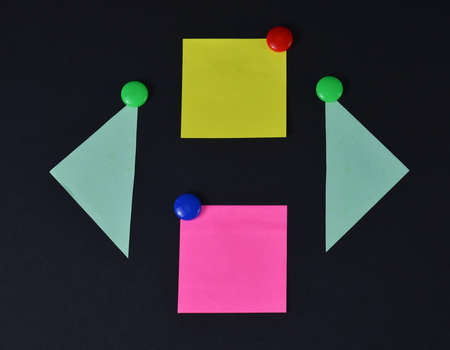 Multicolored stickers on a black background.