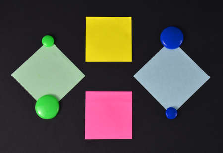 Stickers and buttons on a black background.