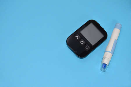 Glucometer on a blue background.の写真素材