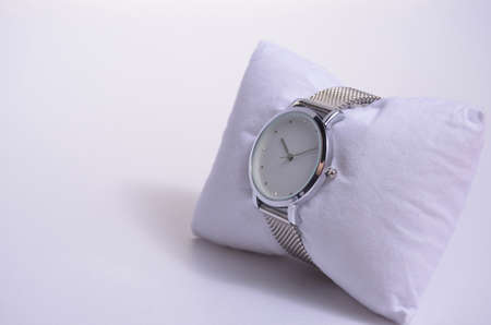 Women's watch on a velvet watch cushion.