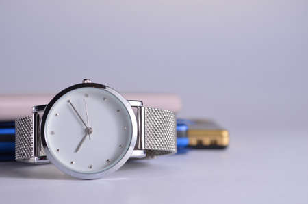 Women's watch on the table. Phone, notepad and flash drive on a white background.の写真素材