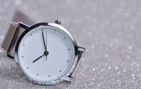 Women's watches lie on a silvery background.の写真素材