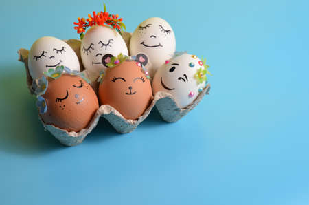 Easter eggs with funny faces on a blue background. Spring. Easter.の写真素材