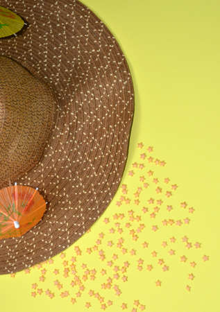 Hat and orange umbrella on a yellow background. Yellow stars.の写真素材