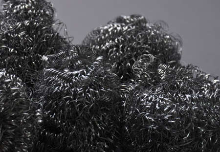 Metal sponges on a gray background.