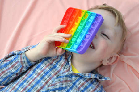 The boy is playing with a toy.