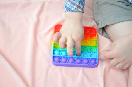 A child plays with a POP IT toy.の写真素材