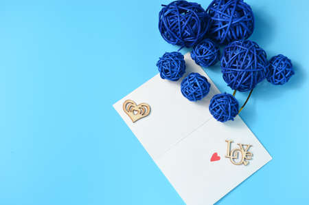 Blue balls on a blue background. Postcard with a heart. Valentine's Day