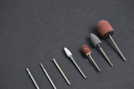 A set of nozzles for a manicure machine. Grey background.