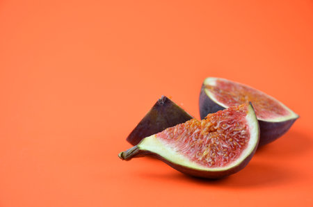Pieces of figs on an orange backgroundの写真素材