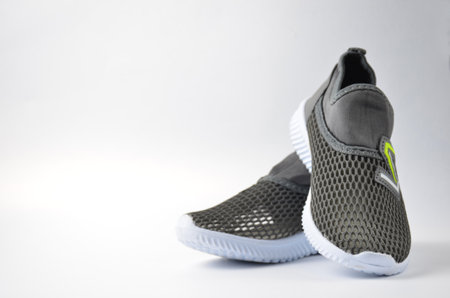 Summer gray sneakers on a white background.の写真素材