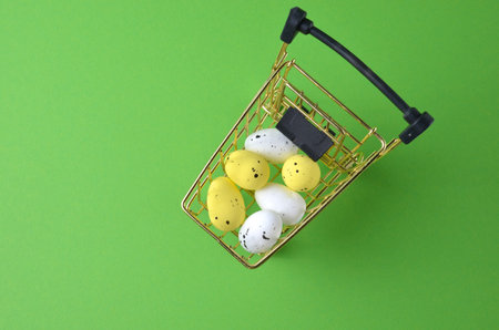 Easter eggs in a grocery basket. green background