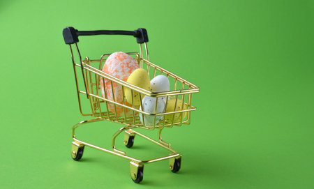 Easter eggs in a grocery basket on a green background.の写真素材