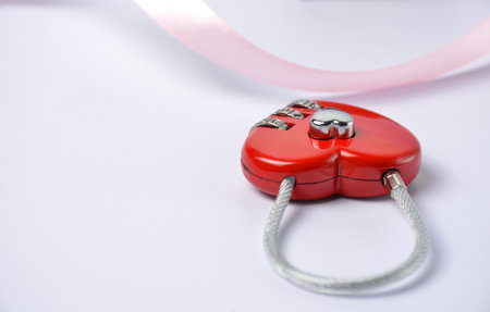 Red padlock in the shape of a heart on a blue background.