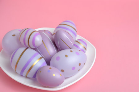 Purple Easter eggs on a plate. Pink background. Easter.の写真素材