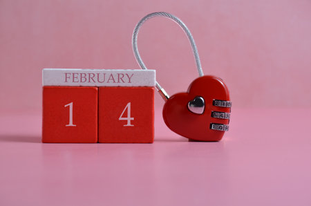 Red heart-shaped lock. Pink background. Valentines Day.