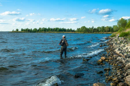 Fisherman in waterの写真素材