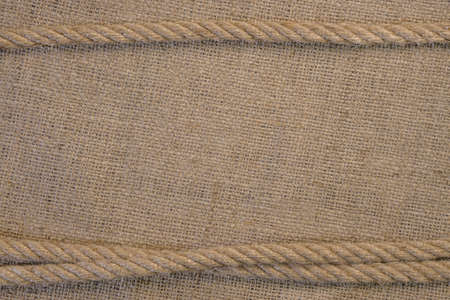 Texture of burlap with cord. Template frame of coarse cloth background