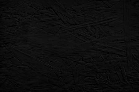 Board painted of black color. Dark OSB wood wall texture backgroundの写真素材