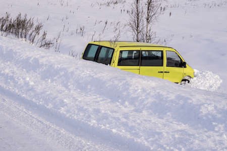 Car in ditch after winter accident. Vehicle loses control and drove off road at ice.