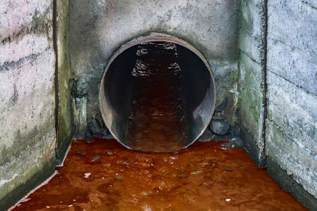 Wastewater pipe. Water pollution discharge of liquid chemical wasteの写真素材