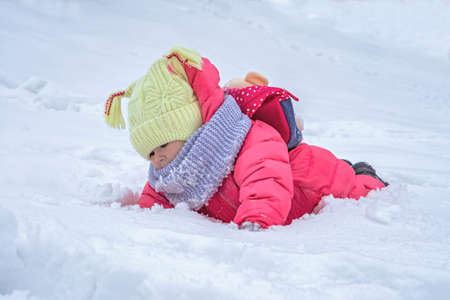 Cute child girl on snow. Winter outdoor activitiesの写真素材