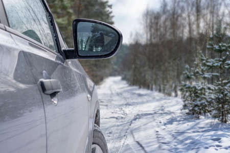 Car vehicle at snowy road in forest. Winter off road trip.の写真素材