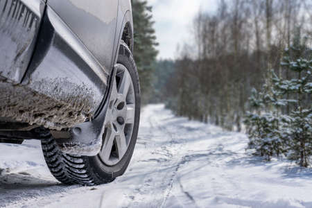 Car vehicle at snowy road in forest. Winter off road trip.の写真素材
