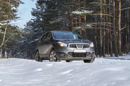 Car vehicle at snowy road in forest. Winter off road trip.の写真素材