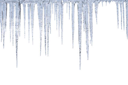 Winter icicles hang from top, isolated on white backgroundの写真素材