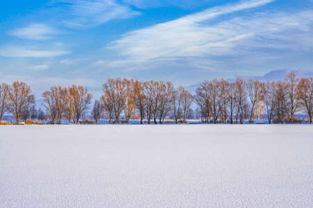 Winter landscape of frozen lake covered snowの写真素材