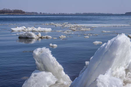 Drifting iceberg floes float on the water. Breaking of the ice on the river in the spring.の写真素材