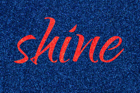 Shine lettering word red (grenadine) on dark blue (navy peony) glitter texture. Shiny sparkle backgroundの写真素材