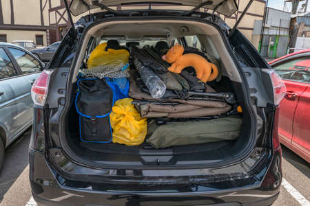 Overloaded trunk of fisherman car before go fishing