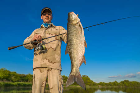 Asp fishing. Happy fisherman with big aspius fish